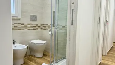 a bathroom with a shower and a toilet and a sink at Chich Suites in the Heart of Historic Rome in Rome