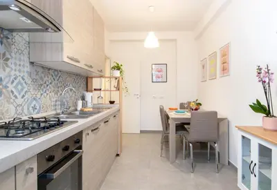 a kitchen with a table and a dining room at Una stanza alPigneto in Rome