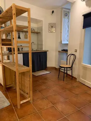 a kitchen with a loft bed and a table at Ideal for your Roman Holidays in Rome