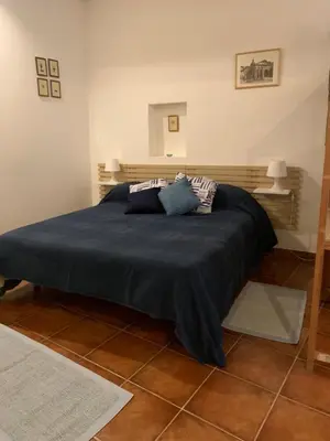 a bedroom with a large bed with blue sheets and pillows at Ideal for your Roman Holidays in Rome