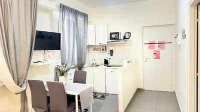 a small white kitchen with a table and chairs at Gemelli tre in Rome