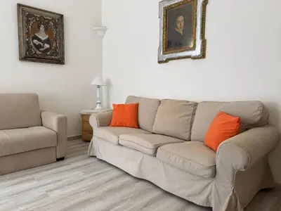 a living room with a couch and a chair at Gianicolense sweet Home in Rome