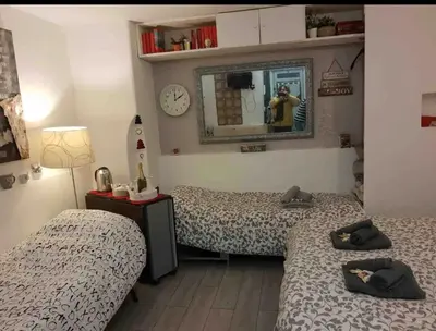 a room with two beds and a mirror at Rome Studio Centro Storico in Rome