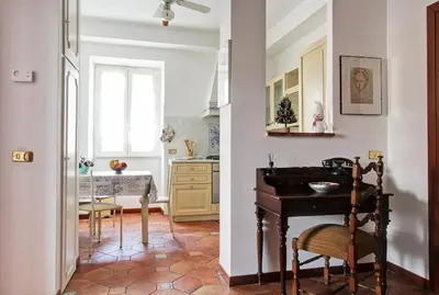 a kitchen with a sink and a table in a room at Home Relax Appia San Giovanni in Rome