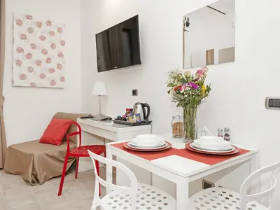 a kitchen and dining room with a table and chairs at Coral flat Colosseo in Rome