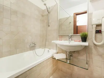 a bathroom with a sink and a bath tub at Coral flat Colosseo in Rome