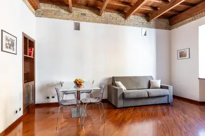 a living room with a couch and a table at La Grande Casa - City Center in Rome