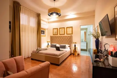 a bedroom with a bed and a living room at SAN GIACOMO 22 Luxury House in Rome