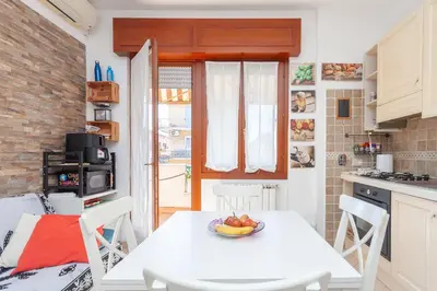 a kitchen with a white table with a bowl of fruit on it at LIVI20 Apartment Gemelli in Rome