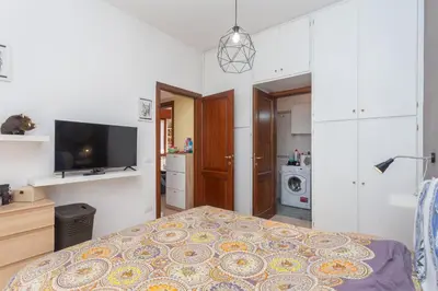 a small bedroom with a bed and a tv at LIVI20 Apartment Gemelli in Rome