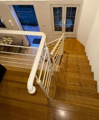 a staircase in a home with a white rail at Kejsi Home in Rome
