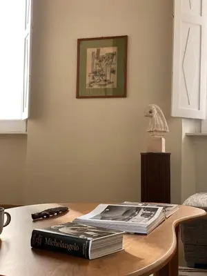 a book sitting on top of a wooden table at Artist apartment in the heart of Trastevere in Rome