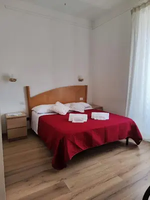 a bedroom with a bed with two towels on it at Guest House Rome Termini Station in Rome