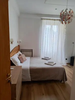 a bedroom with a bed and a large window at Guest House Rome Termini Station in Rome