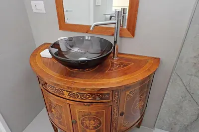 a wooden vanity with a sink and a mirror at Scipioni2 in Rome