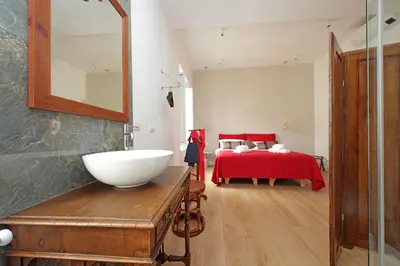 a bathroom with a sink and a bedroom with a bed at Scipioni2 in Rome