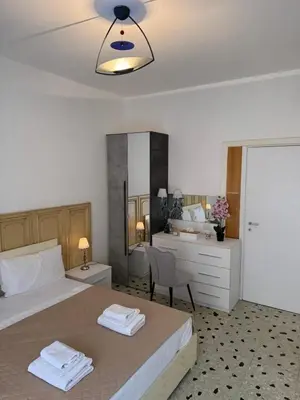 a bedroom with a bed and a bathroom with a mirror at C D Candia Apartment in Rome