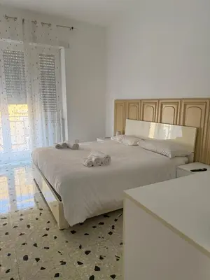 a bedroom with a bed with two towels on it at C D Candia Apartment in Rome