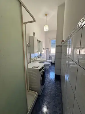 a bathroom with a washer and a washing machine in it at C D Candia Apartment in Rome