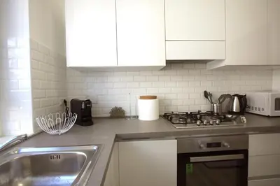 a kitchen with a sink and a stove top oven at Vigna Clara 2BR Holiday House in Rome
