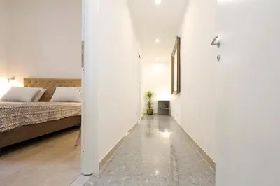 a white bedroom with a bed and a hallway at Piazza Navona in Rome