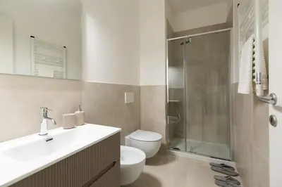 a bathroom with a toilet and a sink and a shower at Casa Dante in Rome