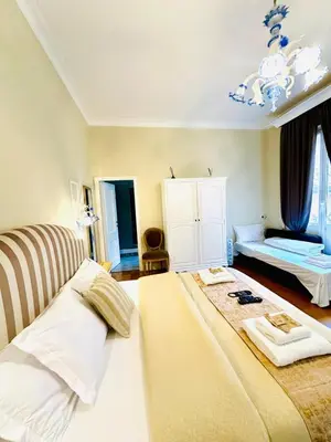 a bedroom with a large bed and a room with a bed sqor at Rome Piazza di Spagna Guesthouse in Rome