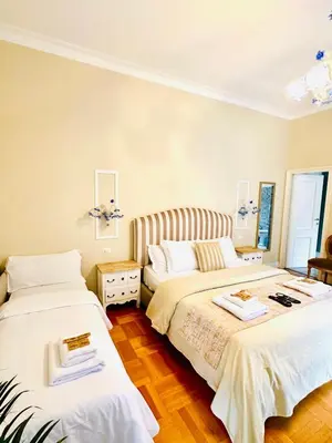 a bedroom with two beds with white sheets at Rome Piazza di Spagna Guesthouse in Rome