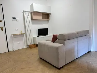 a living room with a couch and a television at Casal Sweet Home in Rome