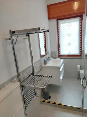 a bathroom with a sink and a ladder in it at Loft Tranquillo e Comodo, Vicino Metro e Vaticano in Rome