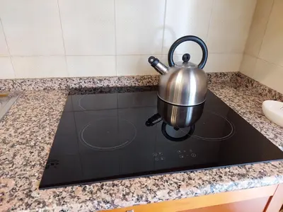 a tea kettle sitting on top of a stove at Loft Tranquillo e Comodo, Vicino Metro e Vaticano in Rome