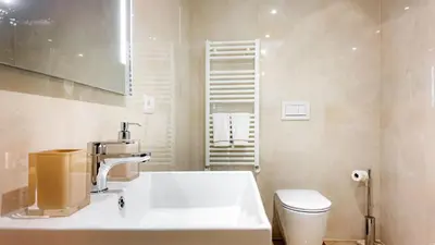 a bathroom with a sink and a toilet at Aura Vatican Suite in Rome
