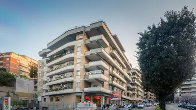 a tall building with balconies on a city street at Aura Vatican Suite in Rome