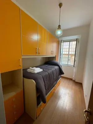 a bedroom with a bed and wooden cabinets at Rachel house in Rome