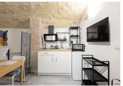 a kitchen with white cabinets and a microwave at Paradise Vatican Home in Rome