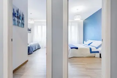 a bedroom with a bed and a blue wall at Vatican Brothers in Rome