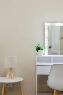 a white bathroom with a mirror and a white desk at Studio Piramide in Rome