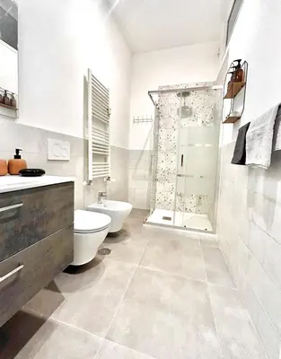 a white bathroom with a toilet and a shower at CASA FRANCISCA - New Boutique Apartment in Rome