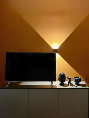 a flat screen tv on a wall with a light at CASA FRANCISCA - New Boutique Apartment in Rome