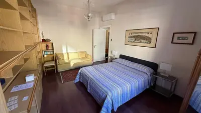a small bedroom with a bed and a chair at Luxury Home Museum - Roma - RAI - Stadio Olimpico - Vaticano - Musei Vaticani - Centro - Clodio in Rome
