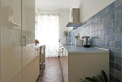 a kitchen with a counter and a sink in a room at A casa di Chloe - Ponte Milvio in Rome