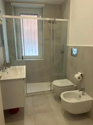 a bathroom with a shower and a toilet and a sink at Charlie Apartment 1C in Rome