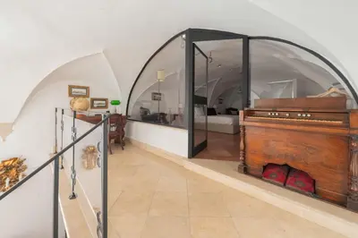 a living room with a white couch and a mirror at Beatrix Apartment in Trastevere by Nosdom Properties in Rome