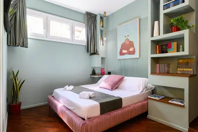 a bedroom with a bed with pink pillows on it at Casina Doria Pamphili in Rome