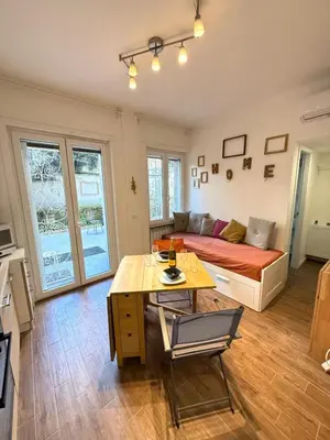 a living room with a couch and a table at Happy House with private garden in Rome