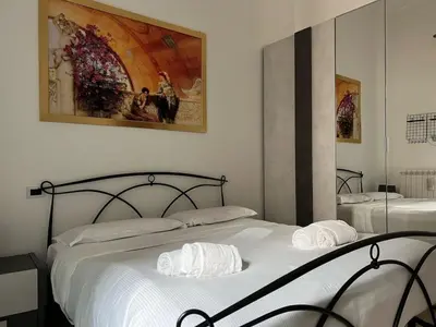 a bedroom with two beds and a painting on the wall at Saint Peter & Giulio Cesare in Rome