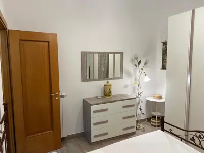a bedroom with a dresser and a mirror on the wall at Saint Peter & Giulio Cesare in Rome