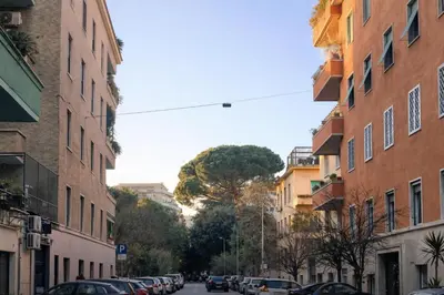 a city street with parked cars and buildings at Eleganza&Confort in Roma-Liberty- in Rome