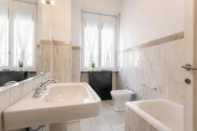 a white bathroom with a sink and a toilet at Eleganza&Confort in Roma-Liberty- in Rome