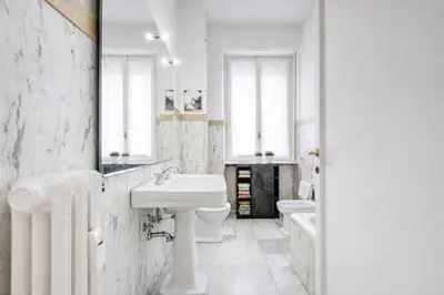 a white bathroom with a sink and a toilet at Eleganza&Confort in Roma-Liberty- in Rome